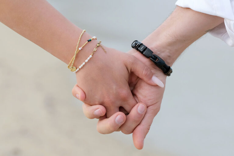 die-verschlungenen-Hände-des-Brautpaares-während-des-Spazierganges-nach-der-Strandhochzeit---meer-sardinien-urlaub