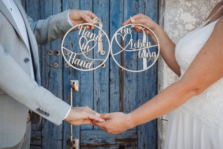 zwei Schildchen mit der bedeutenden Schrift Hand in Hand ein Leben lang, Strandhochzeit - meer sardinien urlaub