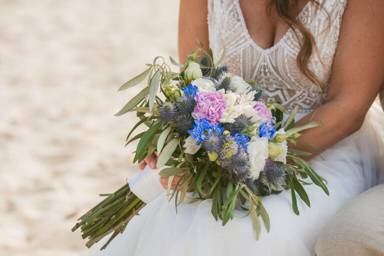 die-Braut-hält-ihren-Brautstrauss,-Strandhochzeit---meer-sardinien-urlaub