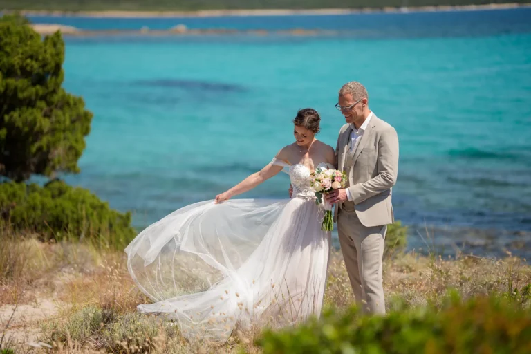die Braut betrachtet ihr Kleid, Strandhochzeit, meer sardinien urlaub