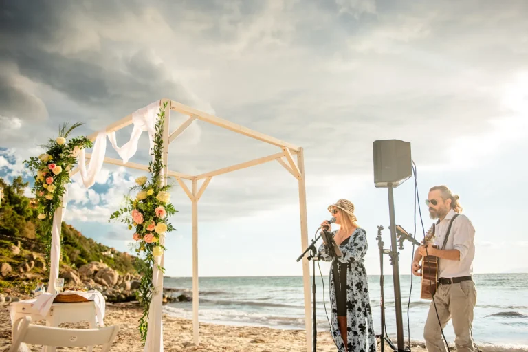 die Musiker neben dem geschmückten Trausetting, Strandhochzeit - meer sardinien urlaub
