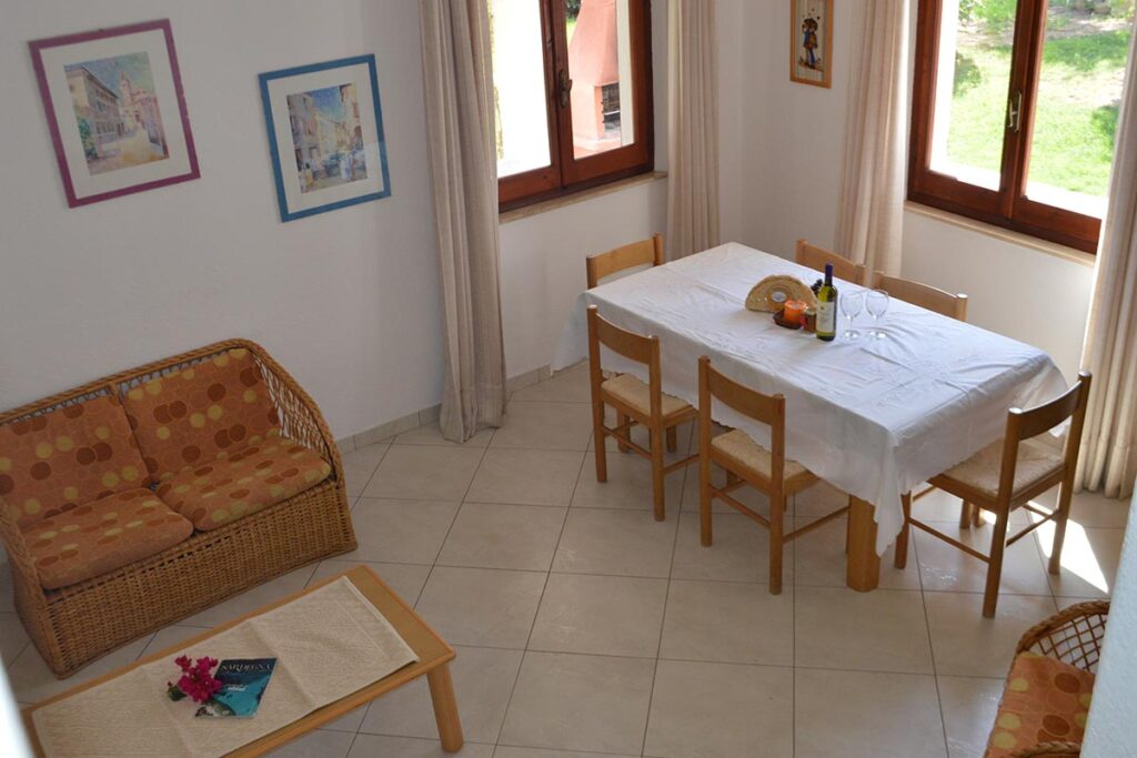 Blick auf den Essplatz ein Schlafzimmer mit Doppelbett des Ferienhauses Borla in Costa Rei - meer sardinien urlaub