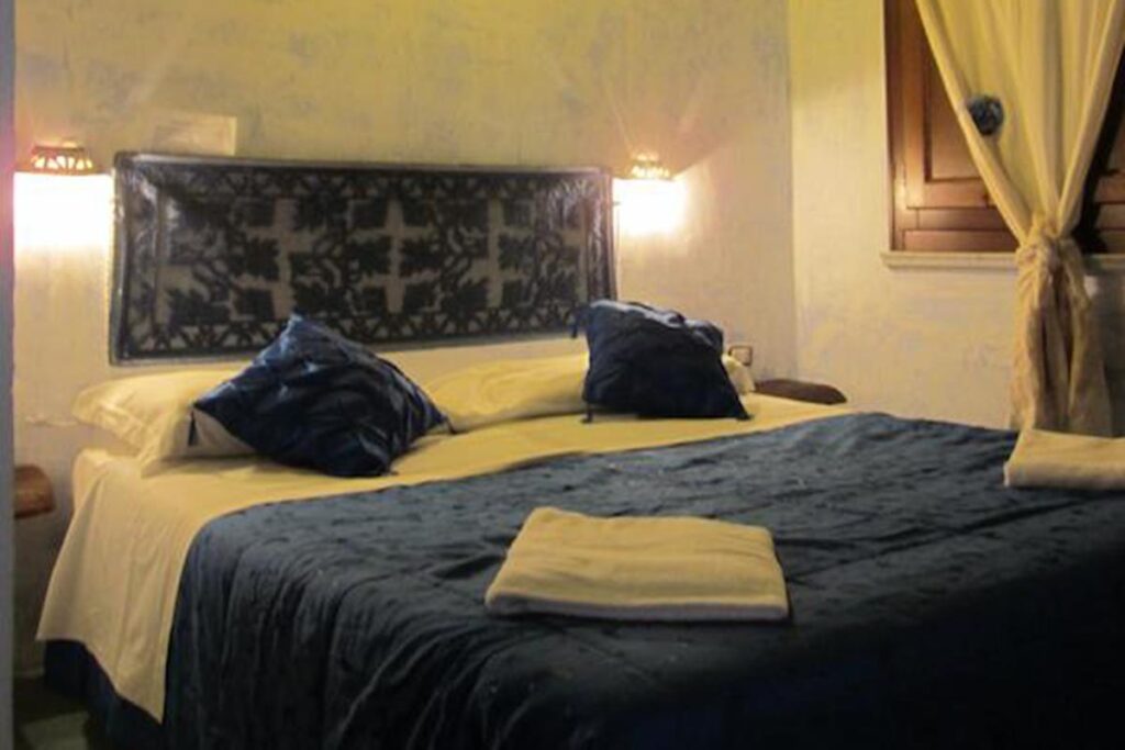 ein Schlafzimmer mit Doppelbett - Agriturismo Neule - meer sardinien urlaub