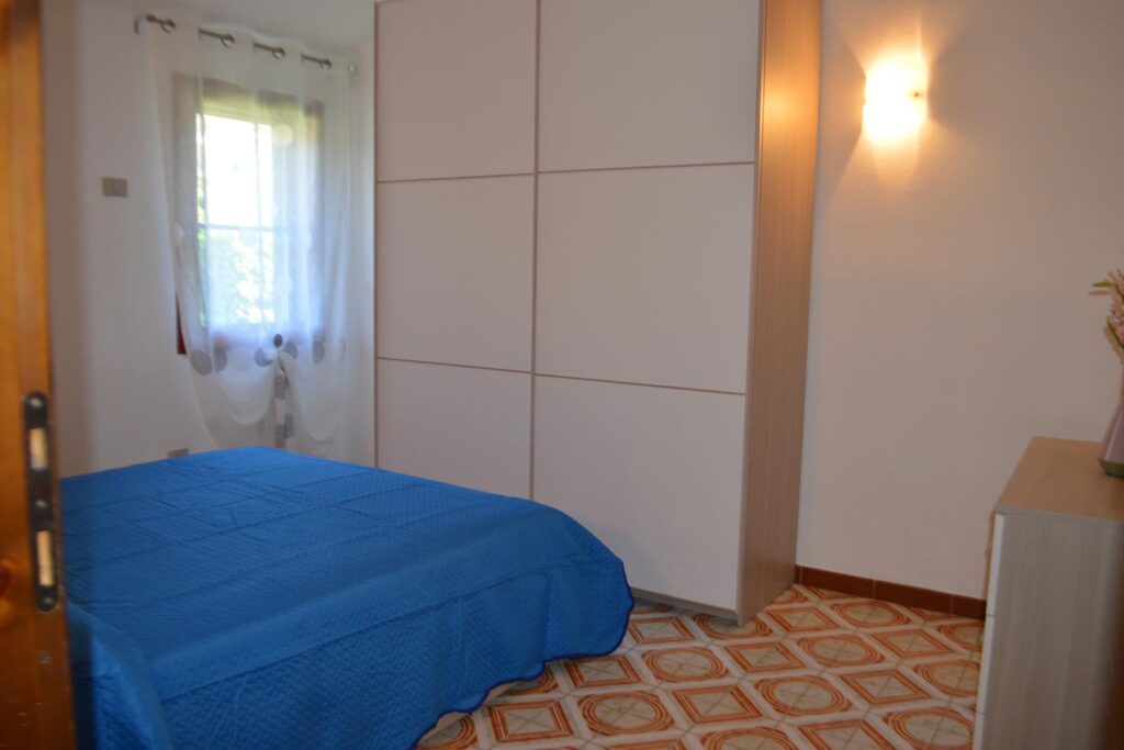 ein Schlafzimmer des Ferienhauses Paluan, Costa Rei - meer sardinien urlaub